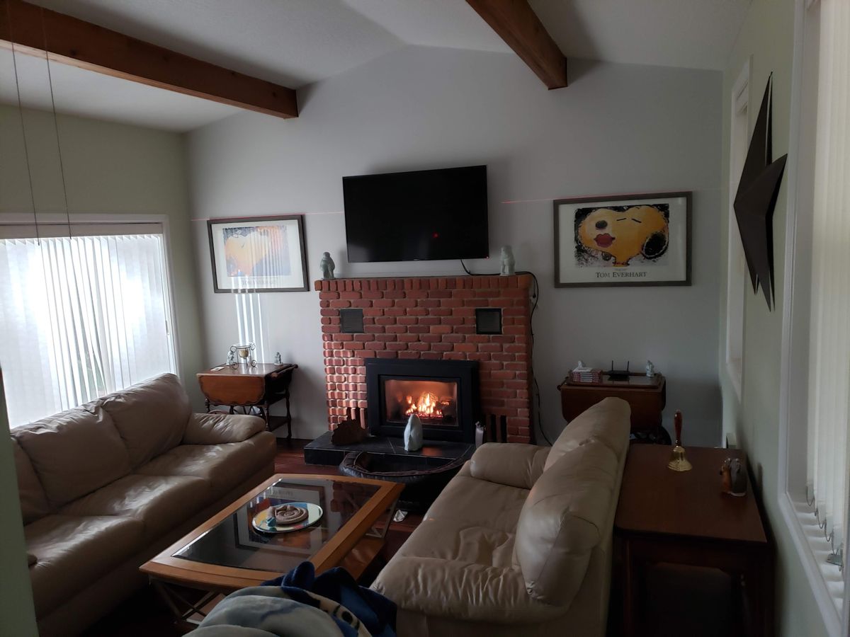 Home boarding living room with fireplace and comfortable seating.